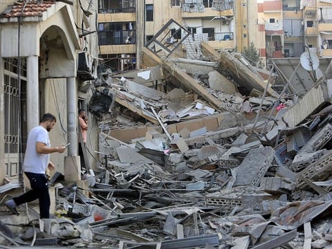  A man walks amid the devastation in the aftermath of an Israeli strike that targeted the Sfeir neighbourhood in Beirut’s southern suburbs.