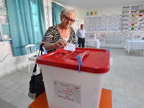 A Tunisian casts her vote in the presidential election at a polling station in Tunis on October 6, 2024.  