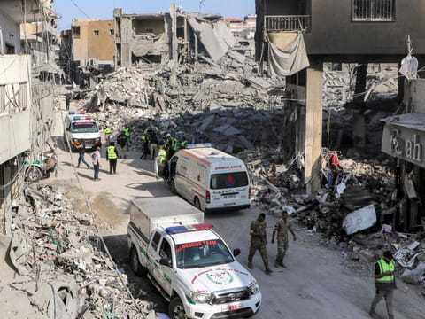 Civil defence rescue vehicles arrive at the site of an overnight Israeli air strike on the village of Qana in southern Lebanon on October 16, 2024.  