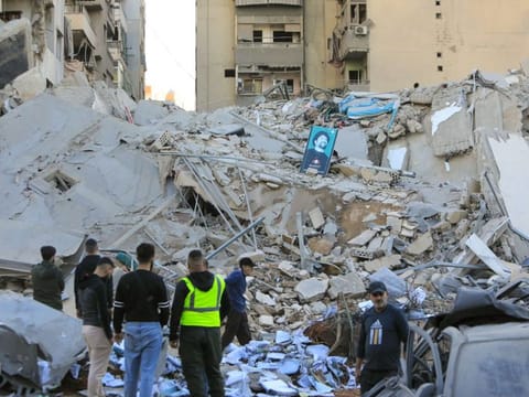 People inspect the damage at the site of an overnight Israeli airstrike that targeted a branch of the Al Qard Al Hassan charity in Beiruts southern suburbs on October 21, 2024.