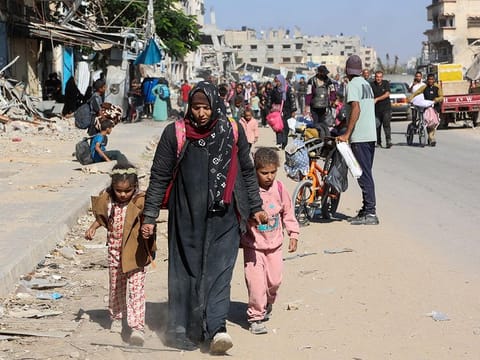 Displaced Palestinians fleeing Israeli military operations in Beit Lahia in the northern Gaza strip walk along the Salah Al Din main road in eastern Gaza City making their way to the city centre, on October 22, 2024, amid the ongoing war in the Palestinian territory between Israel and Hamas. 