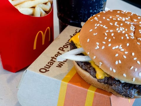 A quarter pounder with cheese, fries, and a drink arranged at a McDonald's restaurant in El Sobrante, California.  