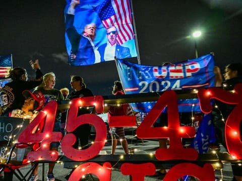 Supporters of former US president and Republican presidential candidate Donald Trump gather to show their support near his residence at Mar-a-Lago in West Palm Beach, Florida, on October 28, 2024.  