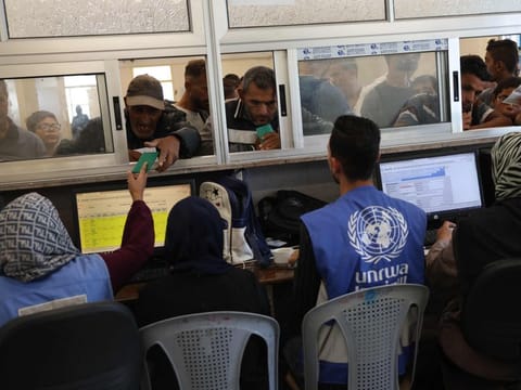 Palestinians queue to receive medicine at the UNRWA Japanese Health Centre in Khan Younis on the southern Gaza Strip on October 29, 2024.
