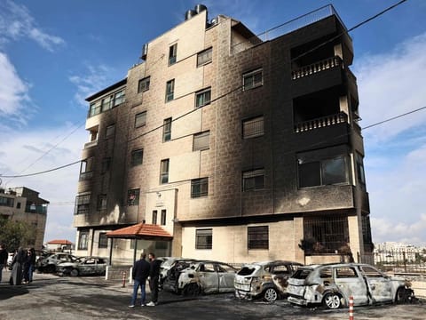The burnt vehicles at the site of a reported attack by Israeli settlers in a residential area on the outskirts of Ramallah city in the occupied West Bank, on November 4, 2024.  