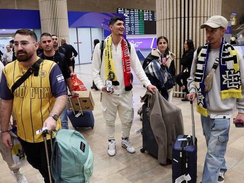 Fans of the Israeli football club Maccabi Tel Aviv arrive at the Ben Gurion International Airport on the outskirts of Tel Aviv on November 8, 2024, upon returning from Amsterdam.   