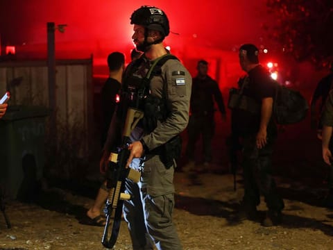 Israeli security forces stand at the scene after a projectile fired from southern Lebanon hit Nahariya in northern Israel, on November 12, 2024, amid the ongoing war between Israel and Hezbollah. 