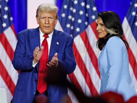 Donald Trump claps as he leaves the stage after speaking alongside former US Representative Tulsi Gabbard during a town hall meeting in La Crosse, Wisconsin, on August 29, 2024. 