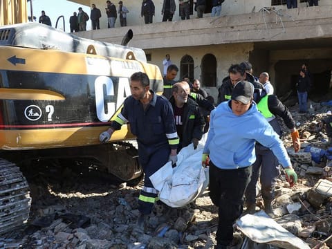 Rescuers evacuate the body of a civil defence officer from the site of an overnight Israeli airstrike that targeted a civil defence facility in Lebanon's eastern village of Douris in the Bekaa valley, on November 15, 2024.  