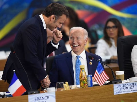 US President Joe Biden (right) talks to France's President Emmanuel Macron during the first day of the G20 Summit in Rio de Janeiro, Brazil, on November 18, 2024.  