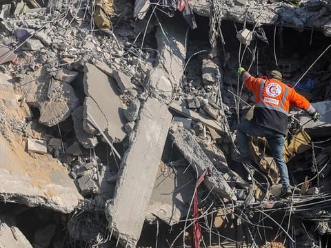 A Palestinian rescuer checks the rubble of a building in the aftermath of an Israeli strike south of Gaza City on November 22, 2024, as the war between Israel and Hezbollah continues.  