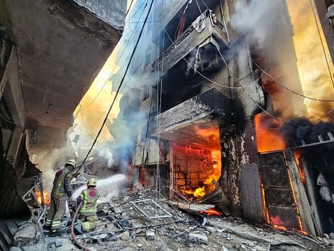 Firefighters battle the flames after a building was hit in an Israeli airstrike in the Hadath neighbourhood of Beirut's southern suburbs on November 23, 2024.  