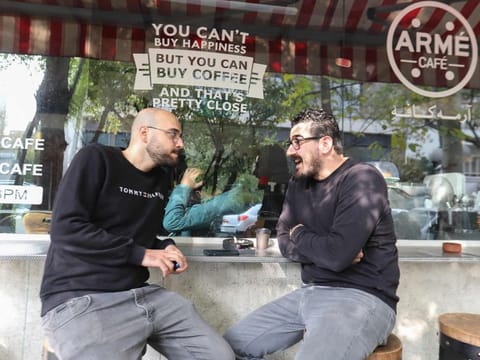 Men sit outdoors in a cafe in the Iranian capital Tehran on November 12, 2024.  “Reducing tension with the US is essential for Iran’s economic stability,” said Maciej Wojtal, chief investment officer at Amtelon Capital.