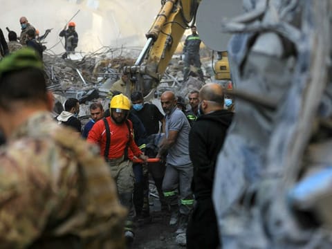Rescuers remove the body of a victim extracted from the rubble of a levelled building, following an overnight Israeli airstrike that targeted Beiruts Basta neighbourhood on November 23, 2024.  