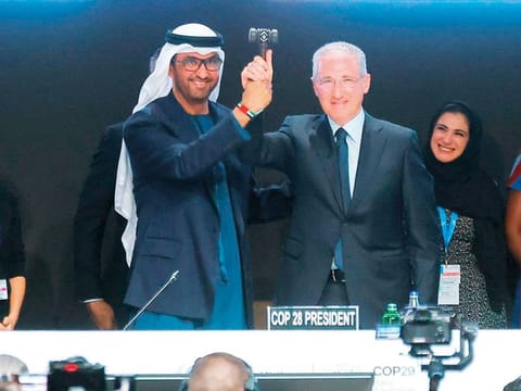 COP28 President Dr Sultan Al Jaber passes the hammer to the COP29 President Mukhtar Babayev at the United Nations climate change conference COP29 opening in Baku, Azerbaijan. At COP29, the UAE urged nations to honour their commitments made at COP28