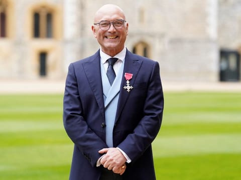 Gregg Wallace poses with his medal after being appointed an Officer of the Order of the British Empire (OBE)  at Windsor Castle, southern England, on February 28, 2023. The BBC faced pressure on December 2, 2024 to take one of its most popular and long-running shows, "MasterChef", off air following claims one of the programme's presenters, Gregg Wallace, engaged in sexually harassing behaviour.  