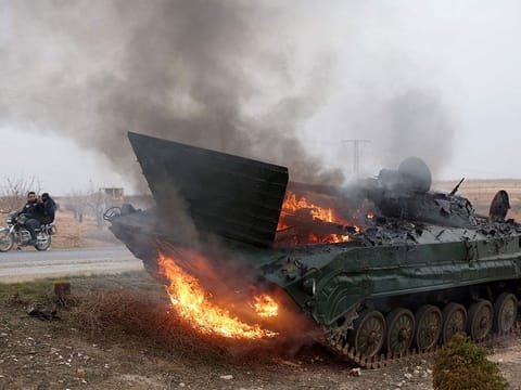 A military vehicle belonging to the Syrian regime forces and seized by anti government forces burn after it was hit by regime forces in the Hama governorate, on December 7, 2024. 
