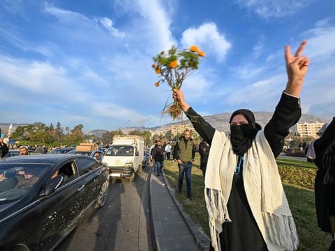 People celebrate at Umayyad Square in Damascus on December 8, 2024.  