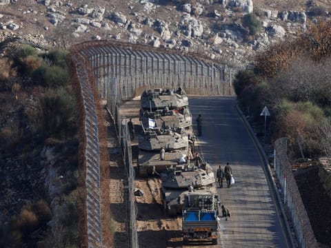 Israeli tanks take position on the border with Syria near the Druze village of Majdal Shams in the Israel-annexed Golan Heights on December 8, 2024.  