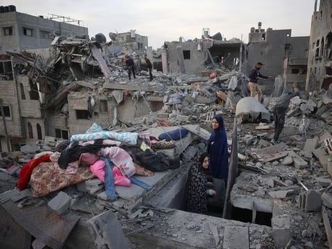 Palestinians inspect the damage after an Israeli strike in the central Gaza Strip on December 7, 2024