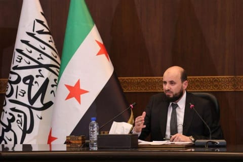 This handout image made available by the Telegram channel of the official Syrian Arab News Agency (SANA) shows Syria's new transitional prime minister Mohammad Al Bashir chairing a meeting of the new cabinet in Damascus on December 10, 2024.  