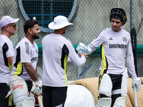 India's Shubman Gill (right) takes a break while Rishabh Pant gets ready to play at the nets during a training session in Brisbane on Friday.