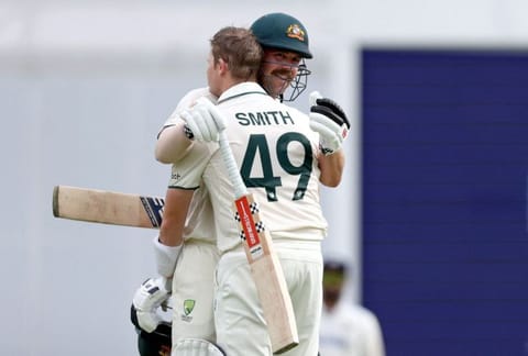 Australia's Steve Smith (left) celebrates reaching his century with teammate Travis Head on second day of the third cricket Test match against India at The Gabba in Brisbane on Sunday.