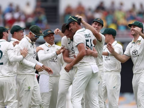 Australia's Josh Hazlewood (centre) celebrates with teammates after dismissing India's Virat Kohli during day three of the third Test at The Gabba in Brisbane on Monday.