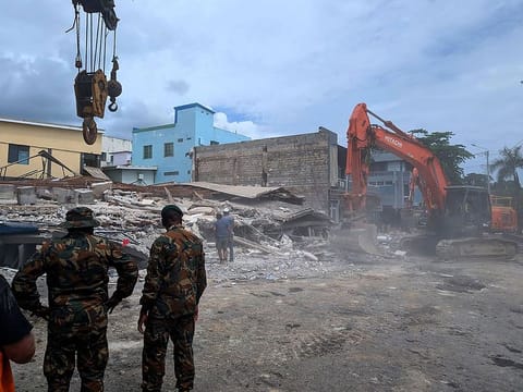 Rescue workers are seen at the site of a collapsed building after an earthquake struck Port Vila, the capital city of Vanuatu, on December 18, 2024. 