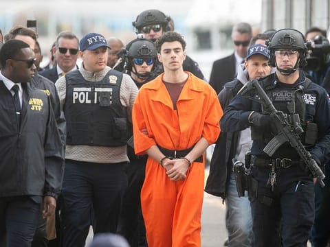 Luigi Mangione, the suspect in the killing of a UnitedHealth Group Inc. chief executive officer Brian Thompson, centre, arrives by helicopter from Pennsylvania in New York, on Thursday, December 19, 2024. Mangione was extradited to New York to face murder charges after he dropped his opposition to the move in court on Thursday. 
