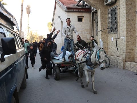 Palestinians transport wounded people into the Al Ahli Arab hospital, also known as the Baptist hospital, in Gaza City on December 19, 2024, as the war between Israel and Hamas militants continues. 