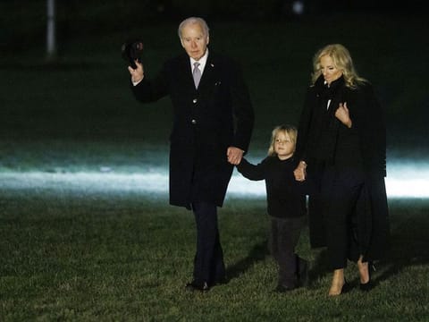 US President Joe Biden, left, First Lady Jill Biden, right, and grandson Beau walk on the South Lawn of the White House after arriving on Marine One in Washington, DC, US, on Thursday, December 19, 2024. 