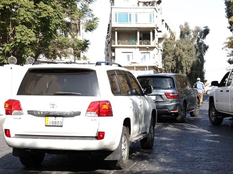 Cars belonging to the US delegation drive in a street in Damascus on December 20, 2024. 