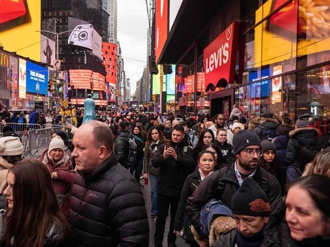Tourists walk in Times Square on December 30, 2024, as preparations are underway for the New Year's celebration in New York City. 
