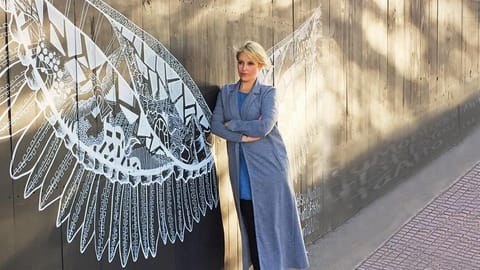 Kelsey Montague with her work in Buenos Aires. The artist has created over 125 murals all over the world 