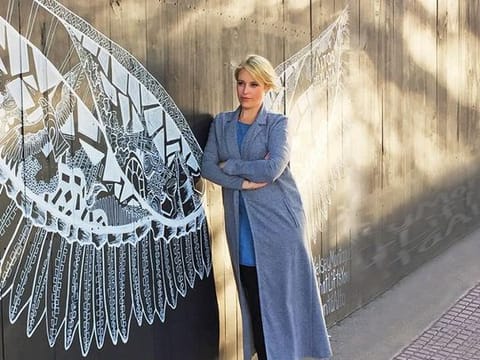 Kelsey Montague with her work in Buenos Aires. The artist has created over 125 murals all over the world 