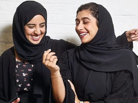 Nour Al Harmoodi and Soukaina Ben Bihi, youth activators, share a light moment at the Hub X 