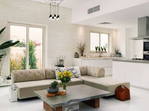 Open Plan: Kitchen from IKEA, the quartz counter from Al Mezoon Marble and the bar stools are Kartell. In the living room, the sofa is from West Elm &amp; coffee table is a custom design
